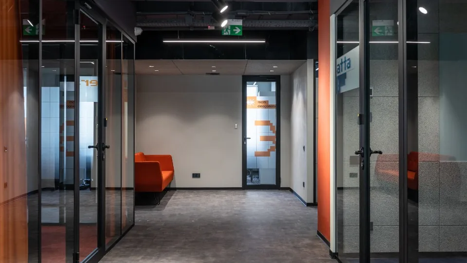 Modern office corridor with emergency exit signs