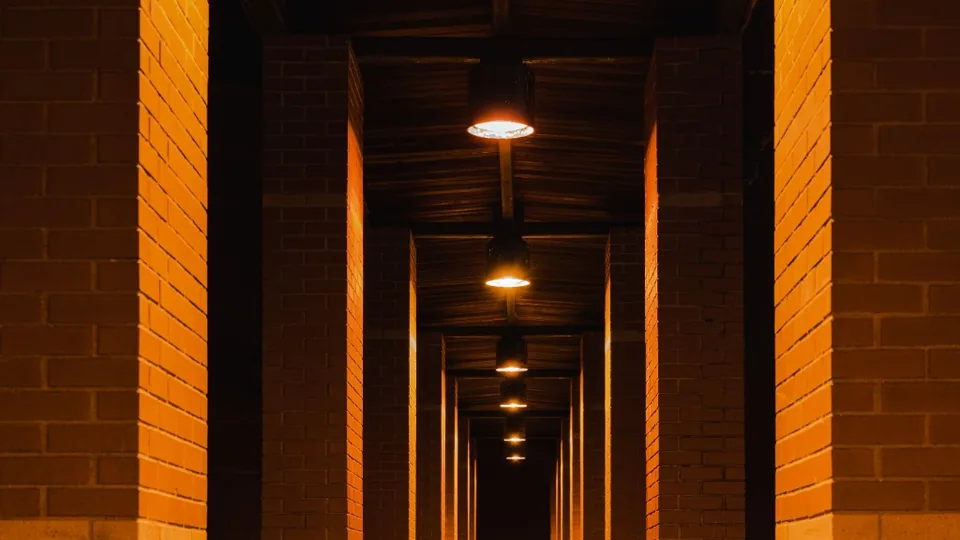 Lit emergency escape route in a brick corridor